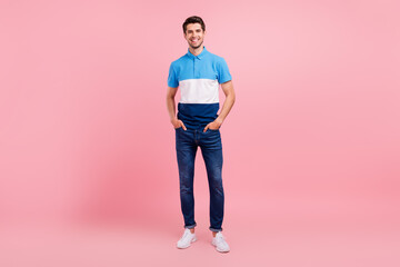 Poster - Full length photo of cool brunet young guy stand wear polo jeans sneakers isolated on pink background