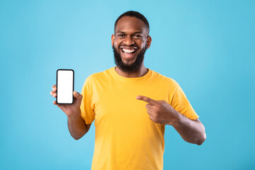 Poster - Excited African American man presenting smartphone with blank screen, offering space for website or app, mockup