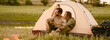 © Drobot Dean - White couple hugging and sitting in tent during camping together