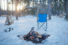 Family Winter Picnic. Bonfire And Camping Chair, Winter Family Walk In Snowy Forest, Outdoor Weekend At Snowing Day, Winter Travel, Horizontal Photo