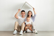 © Prostock-studio - Real Estate. Happy Family With Little Toddler Child Holding Symbolic Cardboard Roof