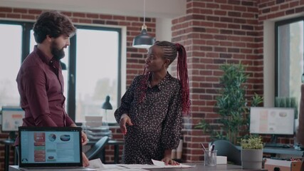 Poster - Multi ethnic team of people giving highfive while working on business project. Woman expecting baby and doing teamwork with colleague to design charts on documents. Pregant employee