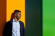 © ADDICTIVE STOCK - Serious black man leaning on bright wall in sunlight