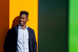 © ADDICTIVE STOCK - Happy black man leaning on bright wall in sunlight