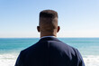 © ADDICTIVE STOCK - Black man enjoying seascape during vacation