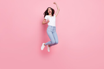 Wall Mural - Full size photo of cheerful young positive woman jump up air winner celebrate isolated on pink color background