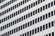 © OlegD - Stone wall of a building with windows on a background