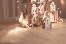 A Small Wooden House With The Number 31 On The Background Of The Advent Calendar With Bokeh Lights.  The Atmosphere Of Celebration, Bokeh Light.