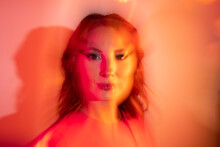Creative Portrait Of Ginger Woman With Orange Led Lights