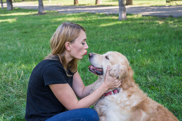 Wall Mural -  woman with her retriever in a summer park.