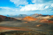 Volcanic landscape in Timanfaya National Park on Lanzarote, Canary Islands, Spain. Dramatic views of volcano craters and desert with black and red lava, ash. Lunar or martian surface