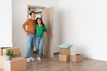 Happy excited couple walking in new house