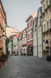 Fototapeta Uliczki - A cozy street with medieval architecture, decorated with flowers.
