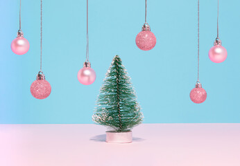 Wall Mural - Christmas tree and pink ball ornaments or Christmas baubles on bright pastel blue background. Christmas and winter holidays concept. Happy New Year card idea.