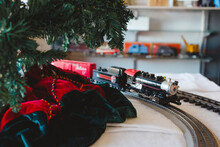 A Model Train And Track Ride Around A Christmas Tree In A Shop