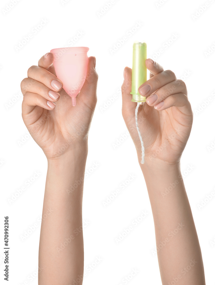 Female hands with menstrual cup and tampon on white background