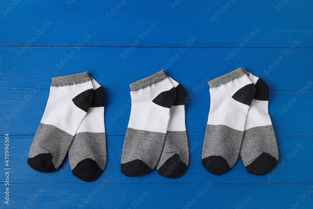Cotton socks on blue wooden background