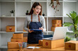 © David - Portrait of Asian young woman SME working with a box at home the workplace.start-up small business owner, small business entrepreneur SME or freelance business online and delivery concept.
