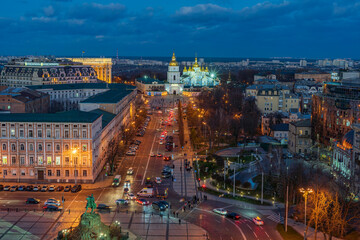 Wall Mural - View of the illuminated St. Michael's Cathedral against the background of the sky with the rising full moon and clouds.