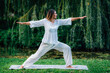 © Microgen - Yoga Woman in Nature. Warrior Pose.