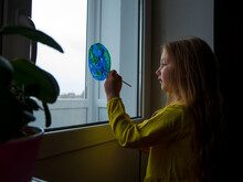Cute Girl Painting Planet At Home Happy Earth Day. Ecology Saving Environment Conscious Consumption