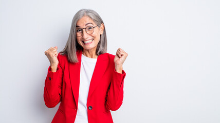 Wall Mural - senior pretty woman feeling shocked,laughing and celebrating success. businesswoman concept