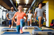 © NDABCREATIVITY - Portrait of happy fit people, friends exercising in gym together. Sport people workout concept