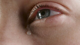 Fototapeta Las - Close-up photo of the woman's tearing eye