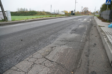 Fused and damaged asphalt road suitable for renovation and posing a threat.