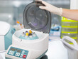 © oleg_ermak - Medical centrifuge. Scientist loading a sample to centrifuge machine in the medical or scientific laboratory