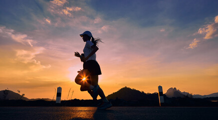 Runners jogging as the sun goes down.