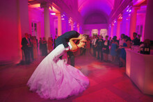 First Dance - Elegant Wedding By Night. Groom Kisses The Bride In A Waltz