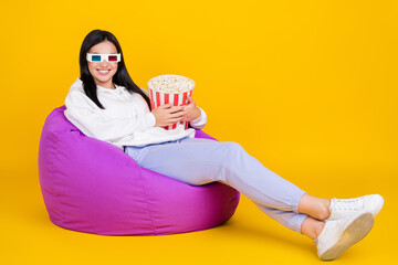 Wall Mural - Full size photo of millennial lady sit bean chair hold pop corn basket isolated over shine yellow color background