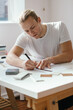 © Austockphoto - Young architect working on a house design vertical