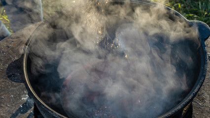 Wall Mural - Mulled wine in a large cauldron. Mulled wine is cooked in a large pot. Vitamins in the traditional festival.