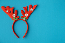 Toy Red Moose Antlers On The Blue Background With Copy Space. Christmas Decoration
