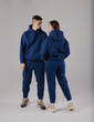Couple posing in studio wearing blue hoodie