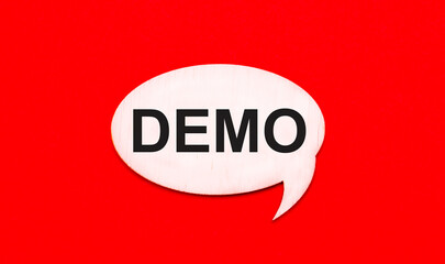 Fototapete - On a bright red background, a light wooden curly card with a dough DEMO