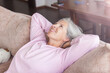 © Tatyana Gladskih - Portrait happy healthy middle aged woman sitting on comfortable couch at home