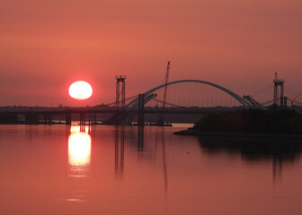 Wall Mural - Sun raising at the bridge construction site in Moline