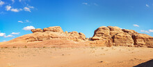 Rocky Massifs On Red Sand Desert, Bright Blue Sky In Background - Typical Scenery In Wadi Rum, Jordan