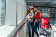 © NFstock - Family with little kid in airport terminal. Traveling by airplane during the vacation. Adventures and emotions concept