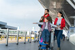 © NFstock - Full length view of the family and children with luggage in airport terminal fly together on vacation. Happy girl playing at the plane