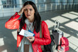 © NFstock - Oh no. Waist up portrait view of the woman wearing backpack holding her hand near her head while standing with passport and tickets at the airport hall and feeling late. Stock photo