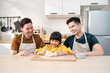 © Kawee - Asian attractive LGBTQ gay family teach girl kid making yeast dough.