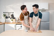 Asian young LGBTQ male gay family enjoy bake bakery in kitchen at home. 