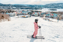 Skiing Woman. Alpine Ski - Skier Looking Mountain Village Ski Resort View Starting Skiing Downhill On Snow Covered Ski Trail Slope In Winter. Mont Tremblant, Quebec, Canada