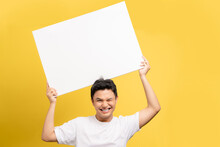 Happy Excited Young Handsome Asian Man Holding Speech Bubble With Empty Space For Text