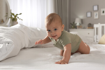 Poster - Cute baby crawling on bed at home