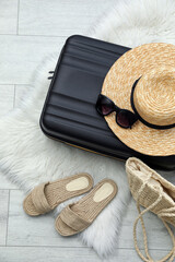 Wall Mural - Suitcase packed for trip and summer accessories on floor, flat lay